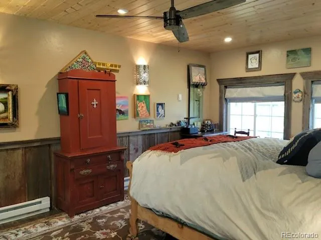 a bed room with a bed and dresser with mirror