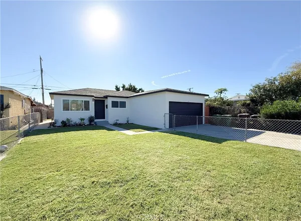 a view of a house with pool and a yard