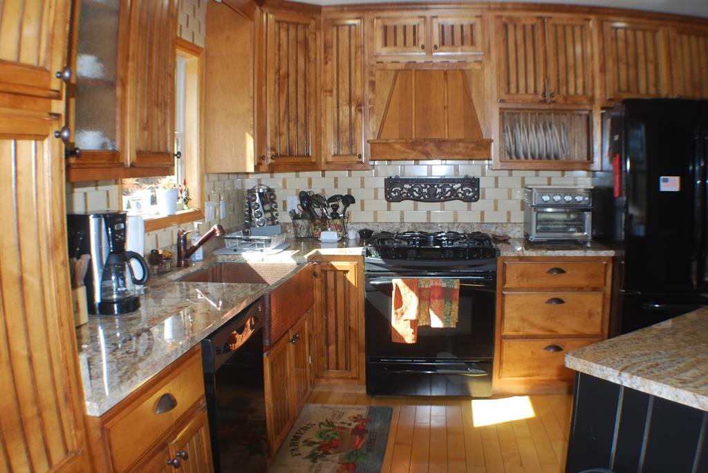 1013 Buck Ridge Drive Murphy, NC 28906 - Photo 12 of 34 a kitchen with stainless steel appliances granite countertop a stove a sink and a microwave