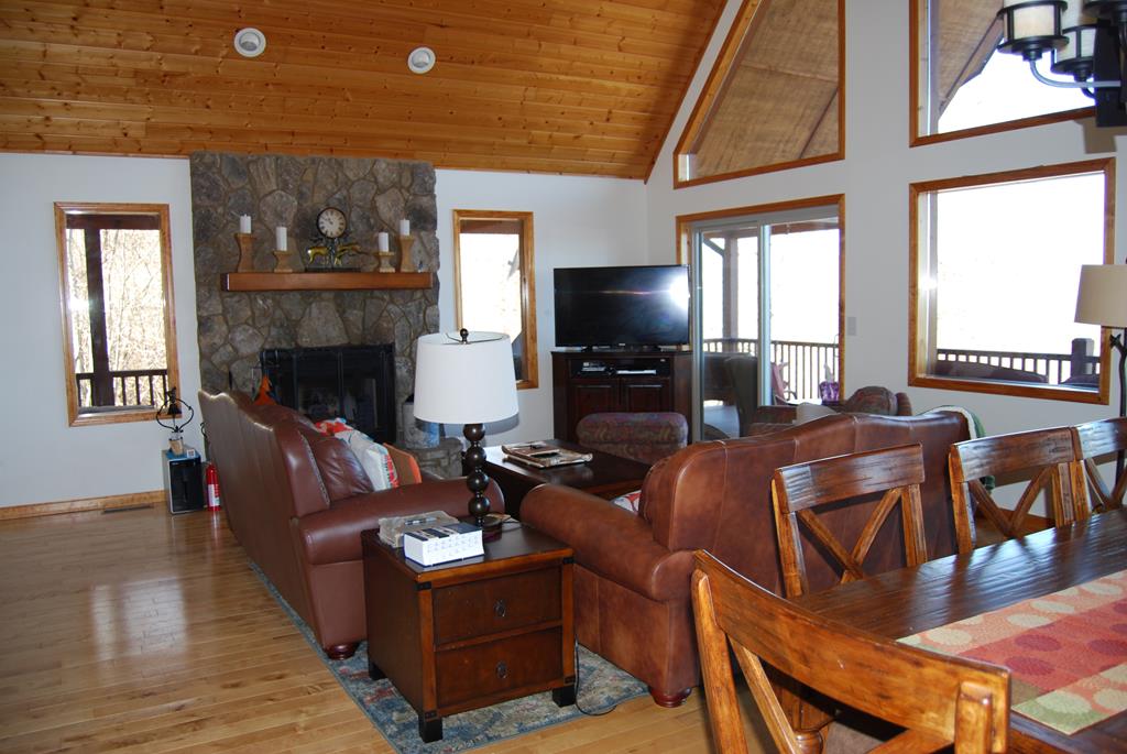 1013 Buck Ridge Drive Murphy, NC 28906 - Photo 19 of 34 a living room with furniture a fireplace and a flat screen tv