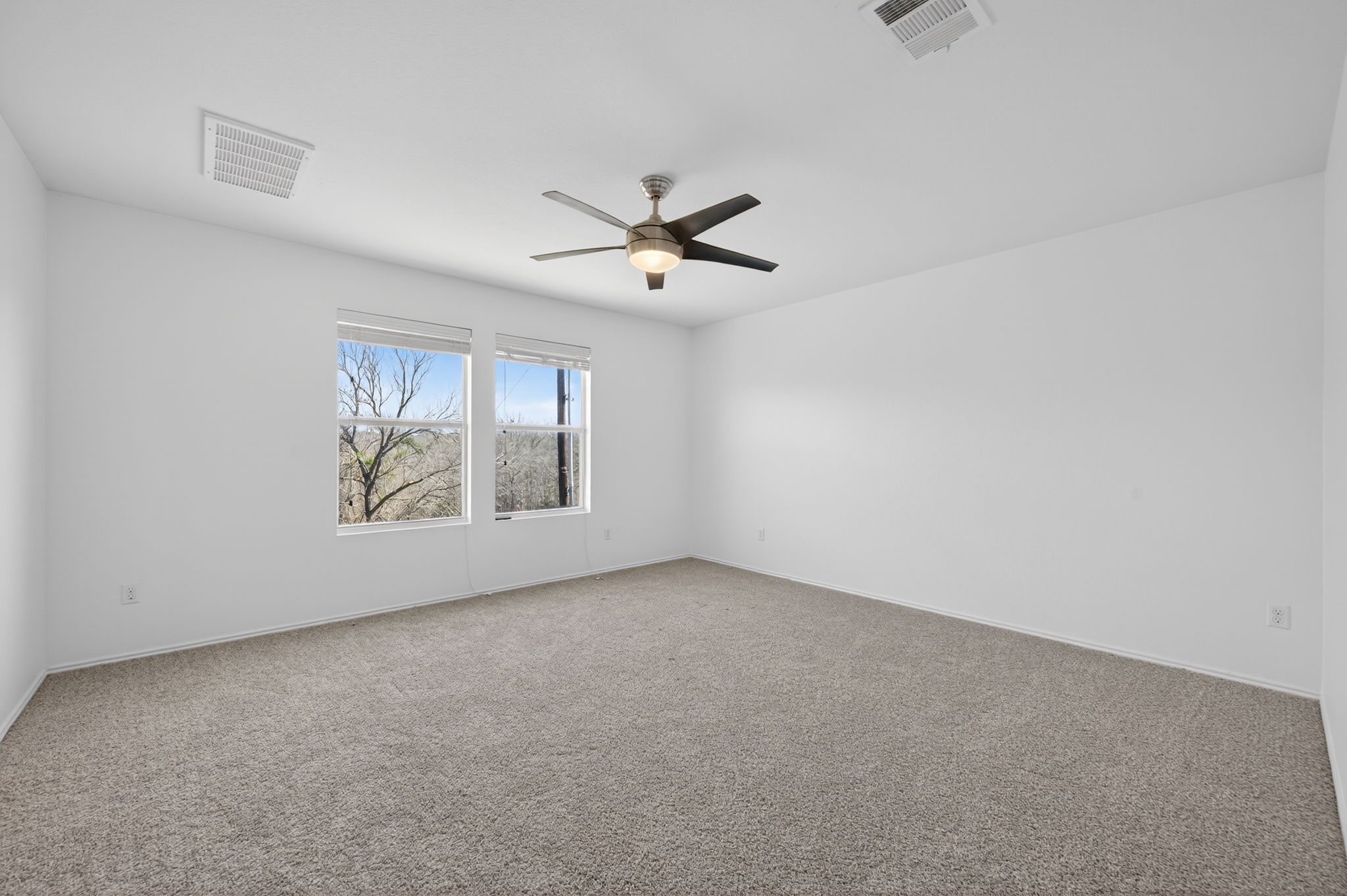 13629 Coomer Path Pflugerville, TX 78660 - Photo 12 of 30 Unfurnished room with light colored carpet and ceiling fan
