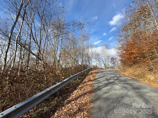 a view of a yard with wooden fence