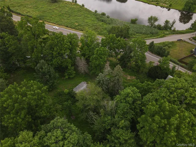 an aerial view of residential house with outdoor space and lake view