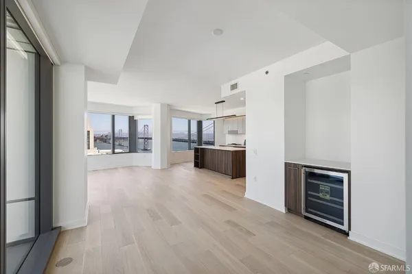 a view of a kitchen with furniture and wooden floor