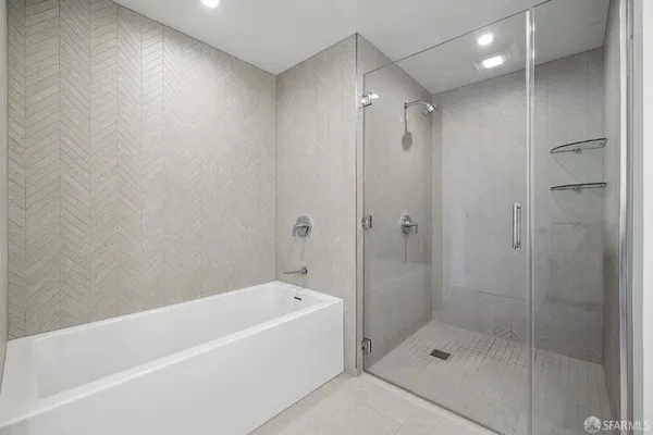 a bathroom with a shower and a bath tub