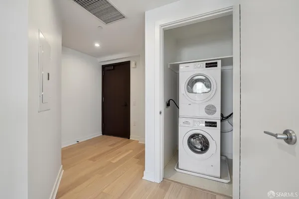 a bedroom with a washer and dryer