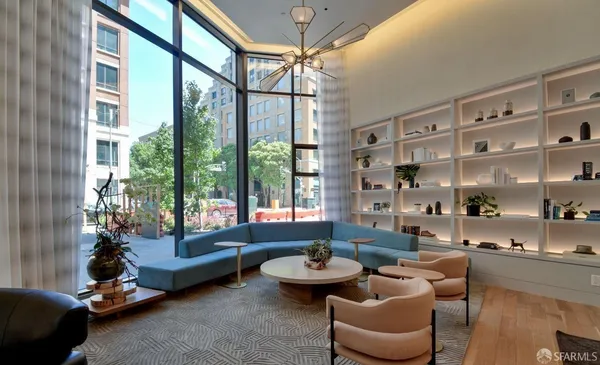 a living room with lots of furniture and a large window