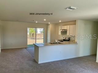 3856 Johannesberg Road North Port, FL 34288 - Photo 2 of 3 a kitchen with stainless steel appliances granite countertop a sink a stove and a refrigerator