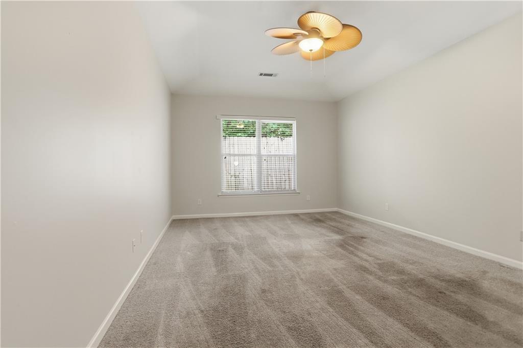 236 Manous Way Canton, GA 30115 - Photo 12 of 25 an empty room with windows and a chandelier fan