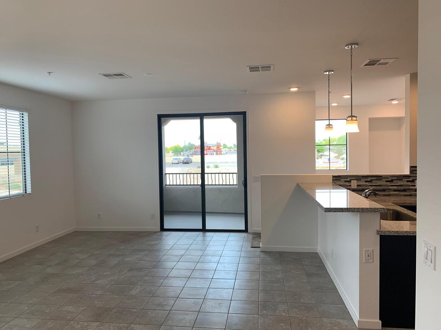 3900 East Baseline Road, Unit 118 Phoenix, AZ 85042 - Photo 17 of 32 an empty room with windows and entrance