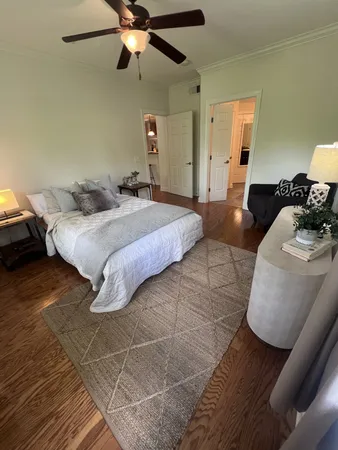 a bedroom with a bed and ceiling fan