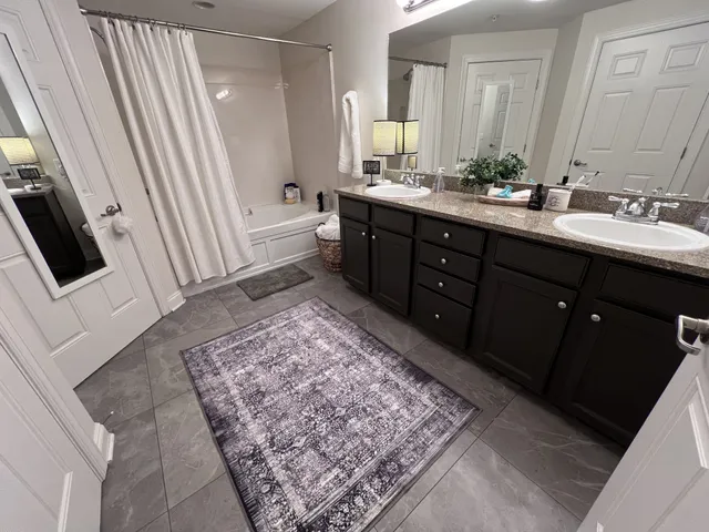 a bathroom with a sink a toilet and mirror