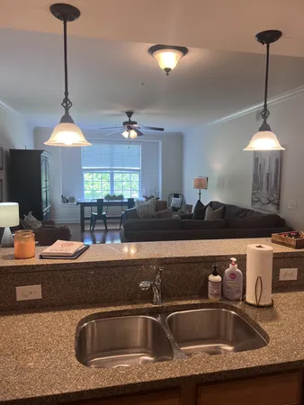a kitchen with a sink a counter and chairs