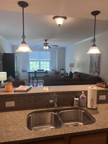 a kitchen with a sink a counter and chairs