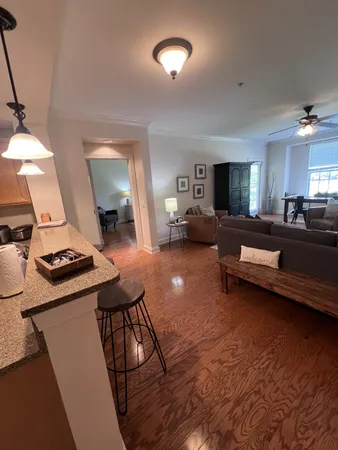 a living room with furniture and a dining table