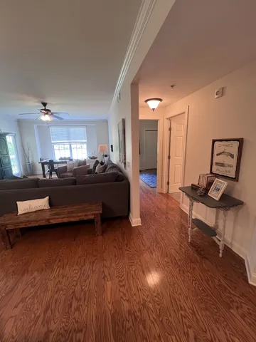 a living room with furniture and a wooden floor