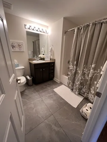 a bathroom with a sink vanity and a mirror