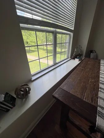 a view of a window with chair and table in a room