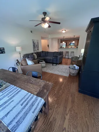 a living room with furniture and a wooden floor