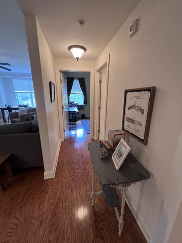 a view of a workspace with furniture and wooden floor