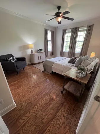 a bedroom with furniture and a mirror