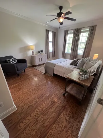 a bedroom with furniture and a mirror