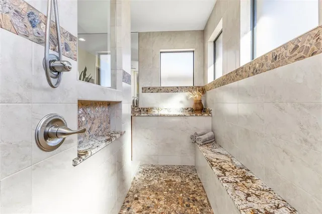 a bathroom with a bathtub and a shower