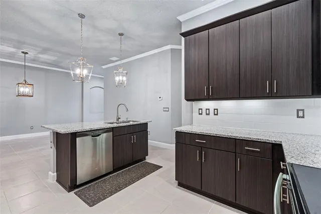 a kitchen with stainless steel appliances granite countertop a sink stove and cabinets