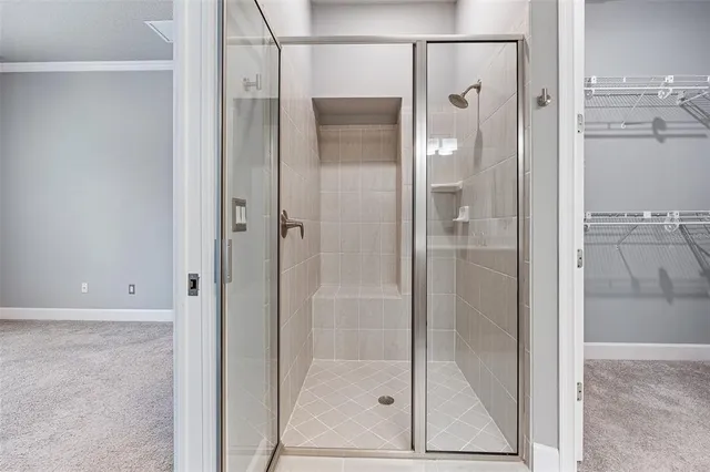 a bathroom with a glass shower door