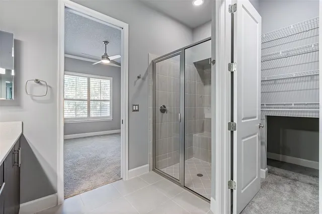 a bathroom with a shower and a glass door