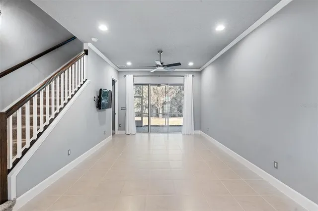 an empty room with windows and stairs