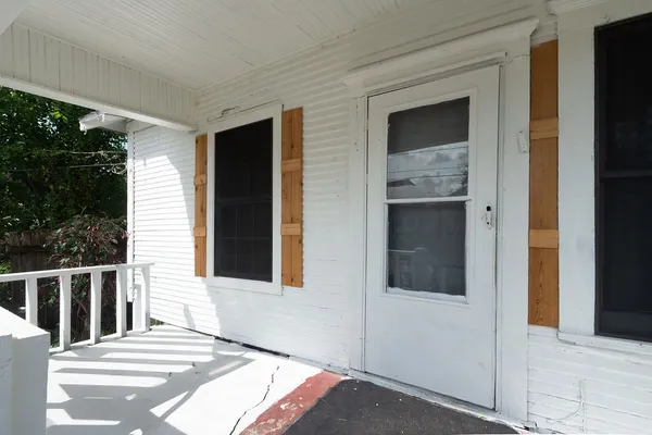 a view of a house with a door and wooden door