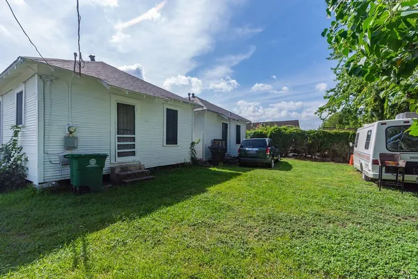 a backyard of a house with table and chairs