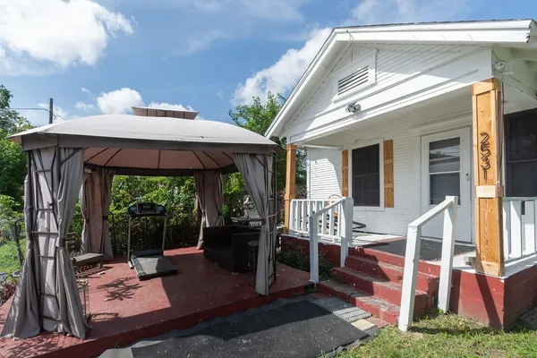 a view of a patio with table and chairs potted plants with wooden floor
