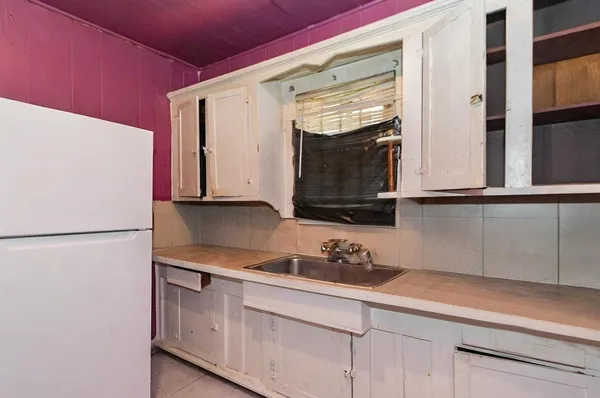 a kitchen with stainless steel appliances white cabinets and a refrigerator