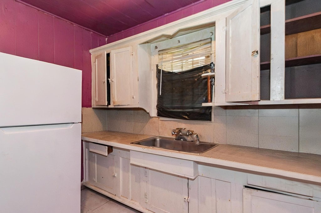 2531 Jones Street Houston, TX 77026 - Photo 8 of 15 a kitchen with stainless steel appliances white cabinets and a refrigerator
