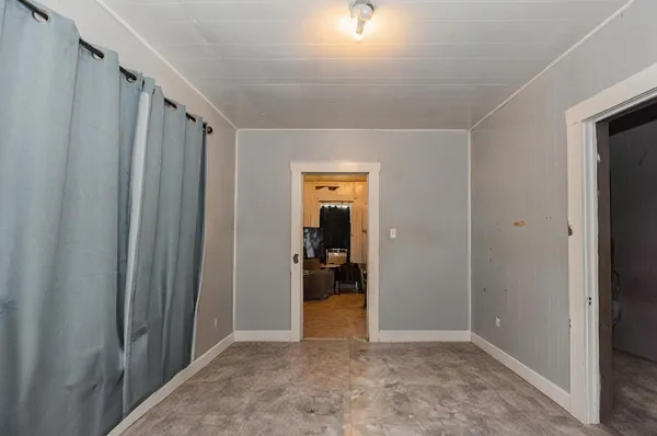 a view of a hallway with wooden shelves