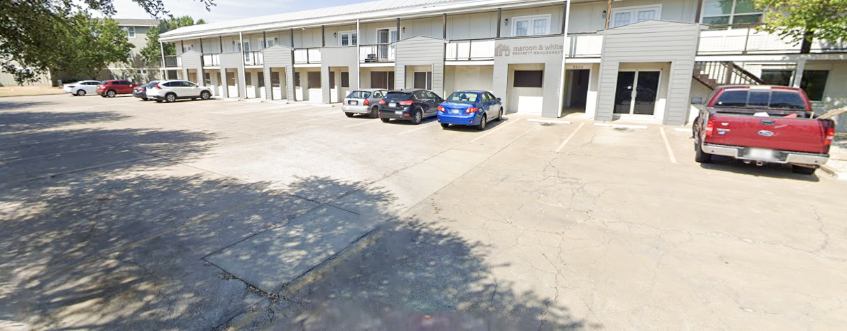 3900 Old College Road, Unit 2 Bryan, TX 77801 - Photo 5 of 11 a view of a building with cars parked in front of it