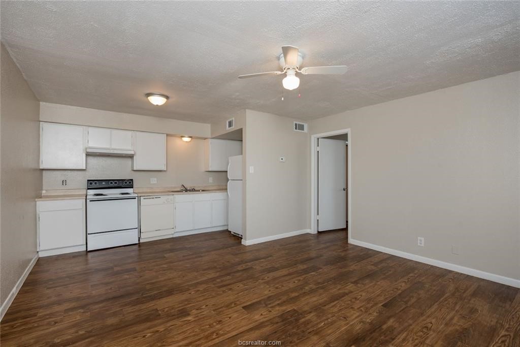 3900 Old College Road, Unit 2 Bryan, TX 77801 - Photo 5 of 10 a view of kitchen with wooden floor and electronic appliances