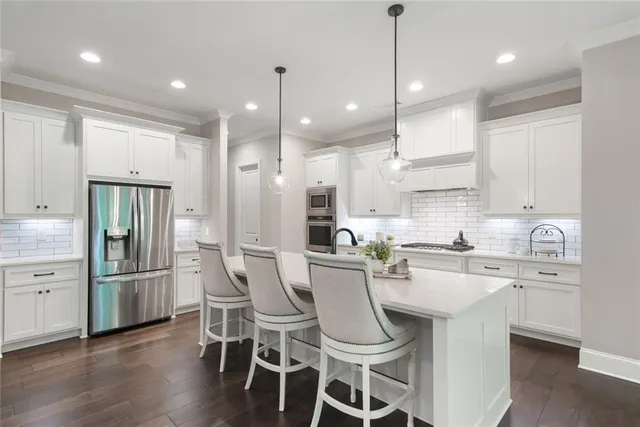 a bathroom with a granite countertop bathtub shower sink vanity mirror and toilet
