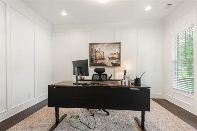 a bed sitting in a spacious bedroom next to a window