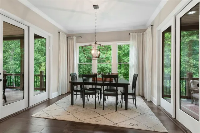 a bathroom with a granite countertop bathtub sink vanity mirror and toilet