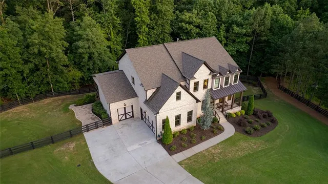 a living room with furniture a fireplace and a large window