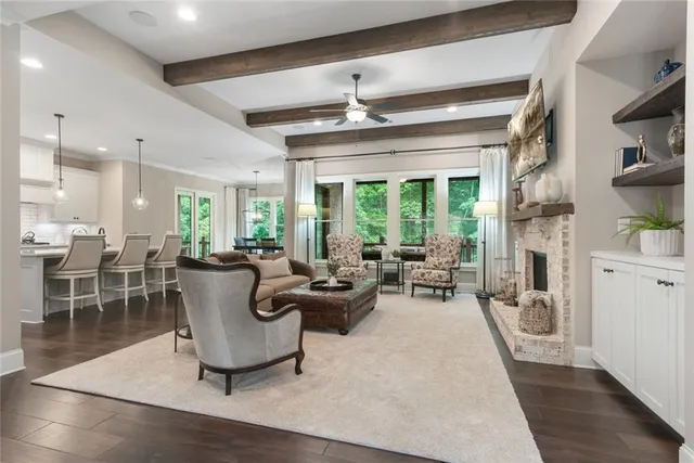 a kitchen with stainless steel appliances kitchen island granite countertop a dining table chairs and white cabinets