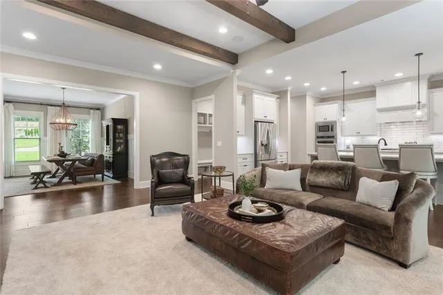 a dining room with furniture and large windows