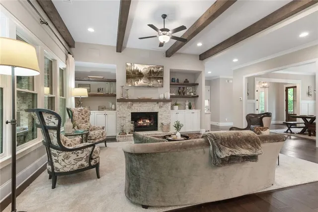 a spacious bedroom with a bed and dresser with mirror