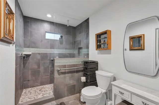 a bathroom with a toilet and a shower