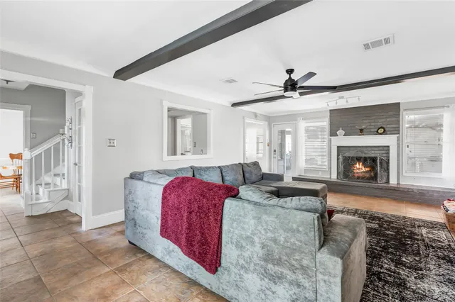 a living room with furniture a fireplace and a fireplace