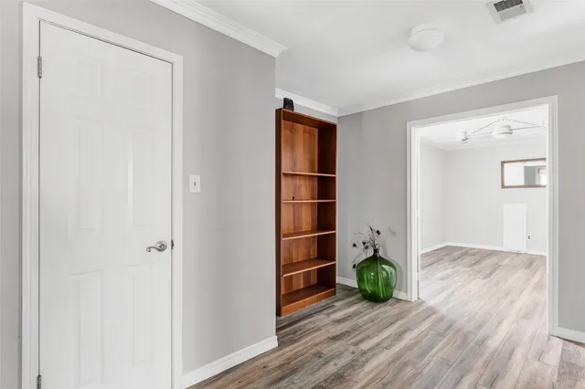an empty room with closet and wooden floor