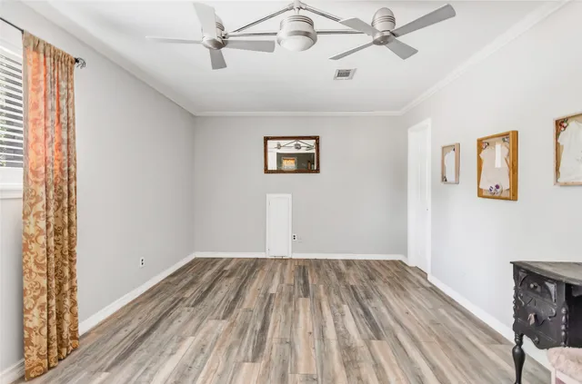 wooden floor in a room next to a window